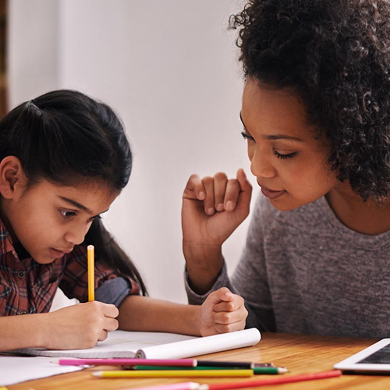 Teacher with student at a desk