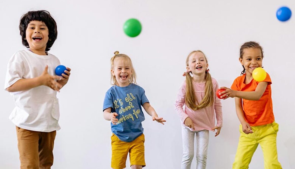 Traditional-Schools-vs-Mastery-Based-Schools-Whats-the-Difference-web Elementary school kids playing with colorful balls and laughing with each other